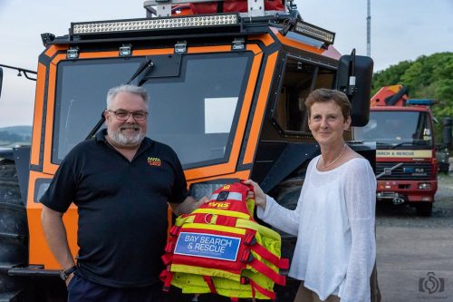 Kate Houlden, Managing Director of Like Technologies, officially hands over the new flotation devices to Bay Search and Rescue