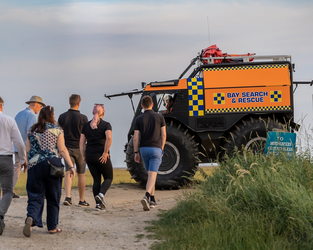 Staff from Like Technologies attend a demonstration from Bay Search and Rescue