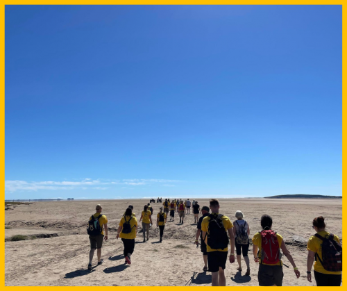 A photo of people walking on Morecambe Bay to raise money for North West Air Ambulance